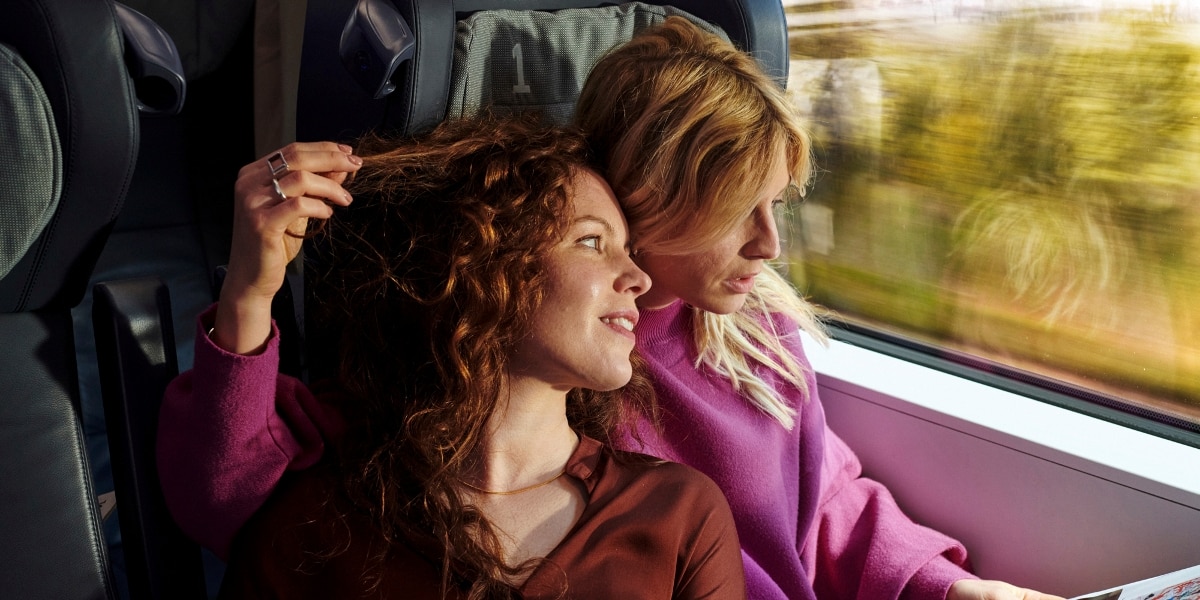 Couple traveling comfortably in a Deutsche Bahn first-class carriage