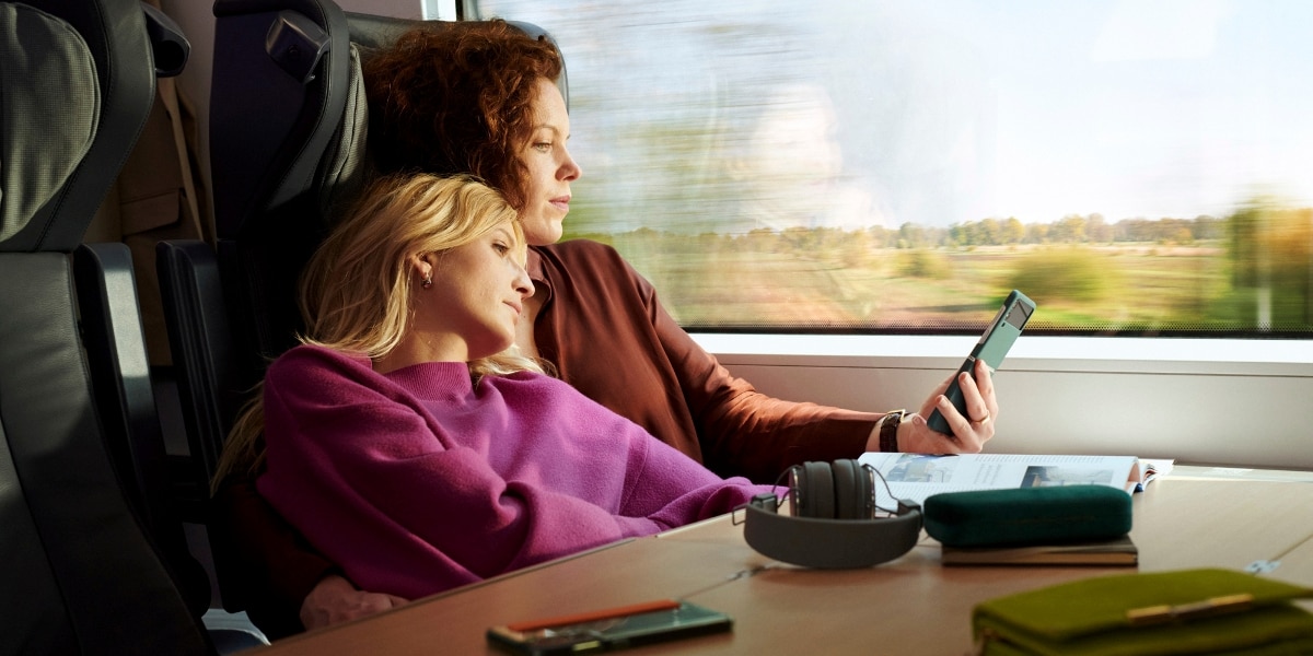 Couple in a Deutsche Bahn first-class car, comfort-oriented travel