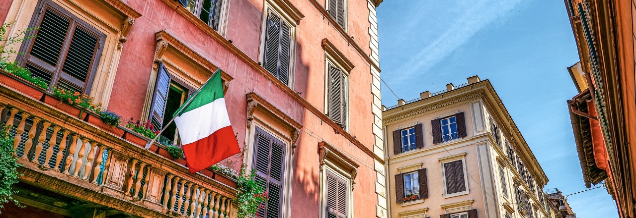 A picturesque street with an Italian flag in the Monti district in the historic heart of Rome