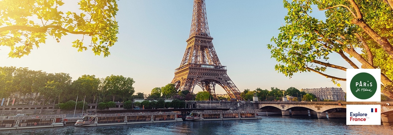 Low Angle View Of Eiffel Tower Against Clear Sky With Lake In Foreground