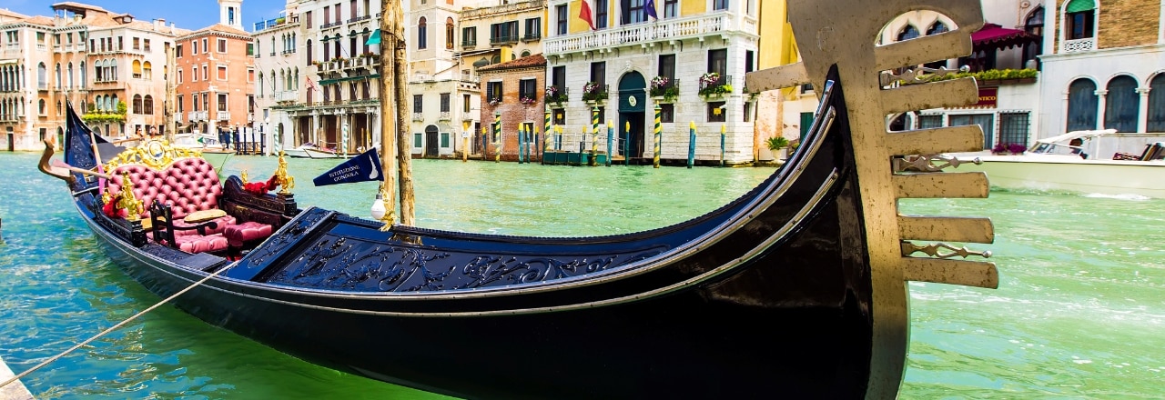 Tourists travel on gondolas at canal Venice, Italy