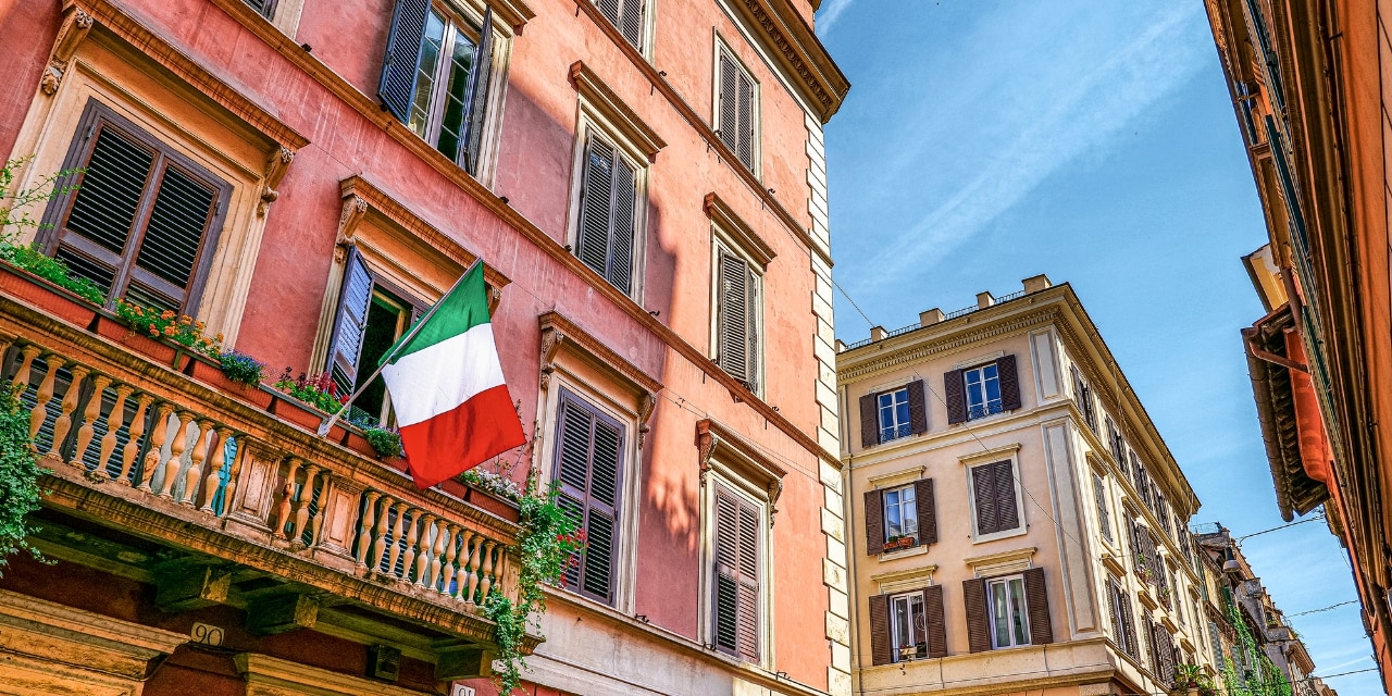 A picturesque street with an Italian flag in the Monti district in the historic heart of Rome