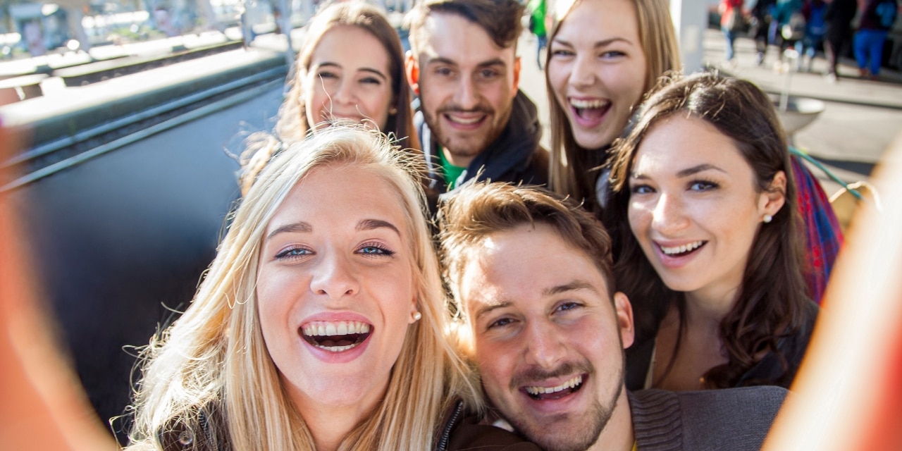 Group selfie of young people traveling