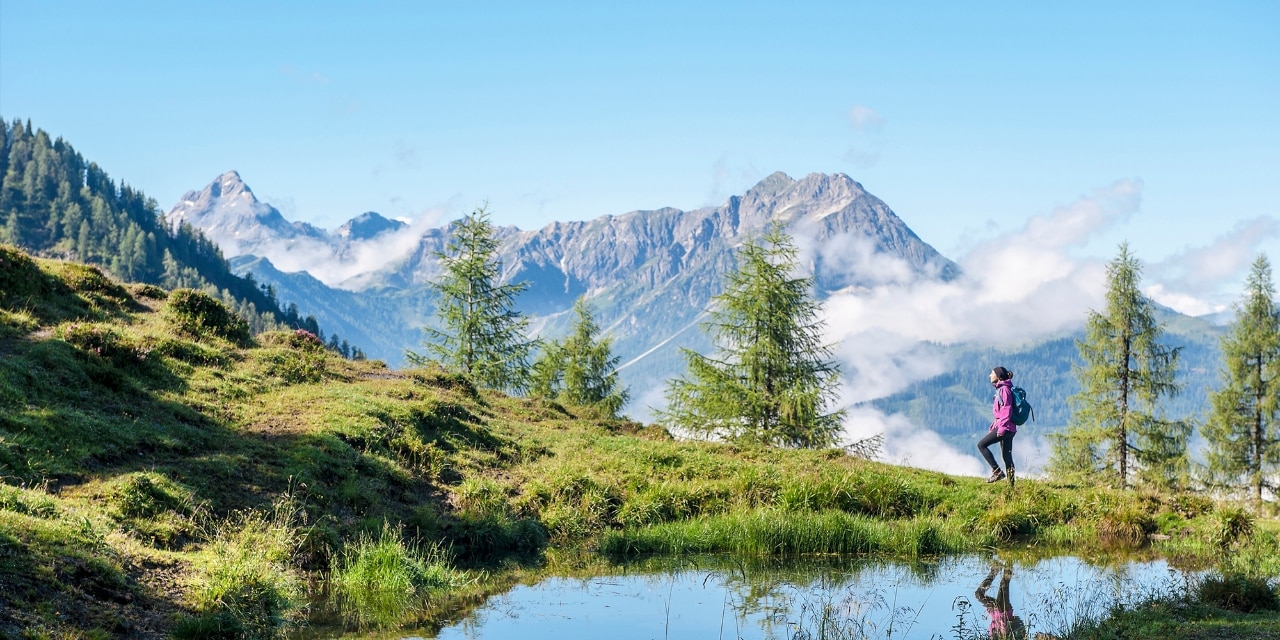 Austria, Salzburg State, Young woman hiking in mountains