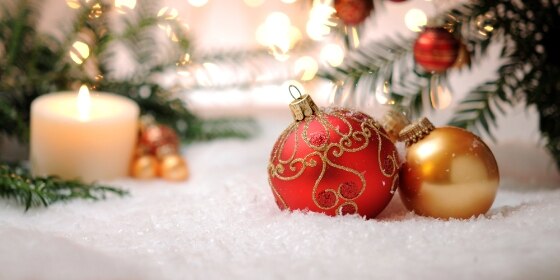 Candle with christmas balls and pine tree
