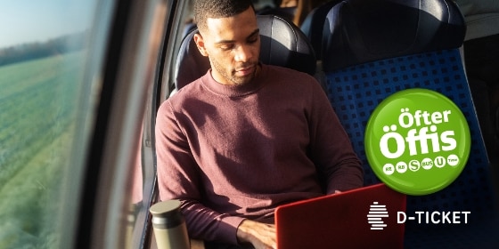 Junger Mann mit Laptop im Regionalzug