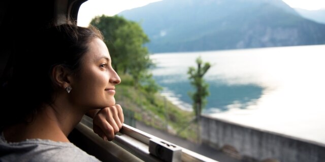 Smiling woman looking at the view from train
