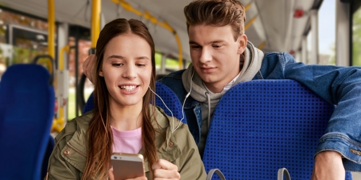 Junge Leute mit Handy im Bus