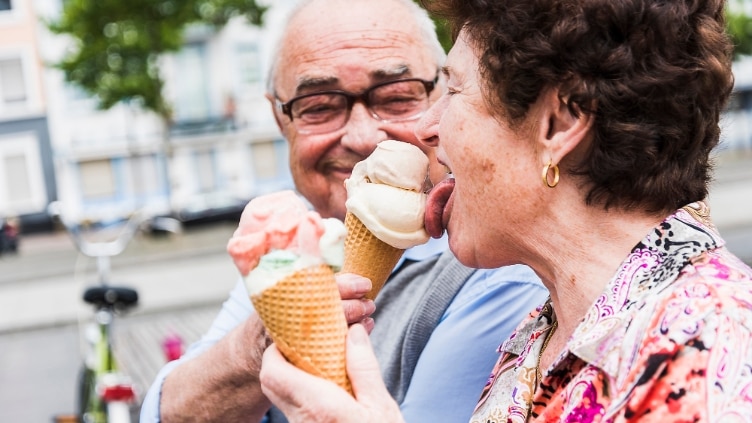 Senior couple enjoy eating ice cream together