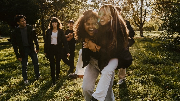 Cheerful friends having fun in park